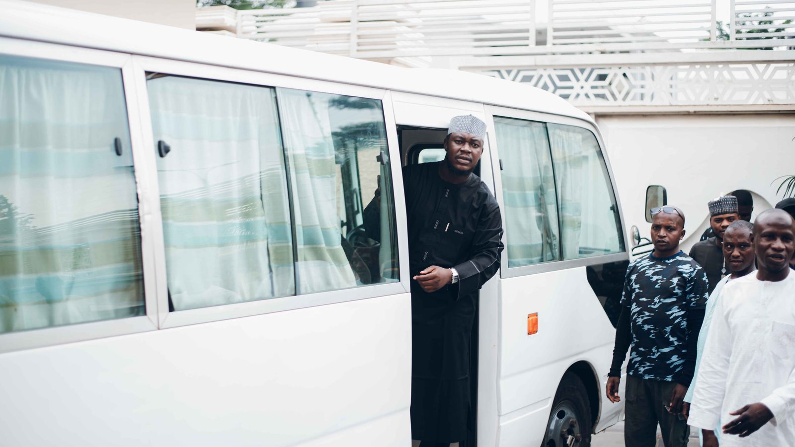 Mini coach loading passengers outside a conference centre