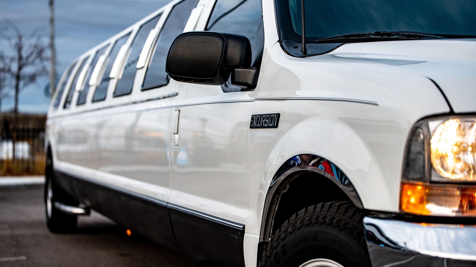 Stretch SUV limousine with doors open under city lights